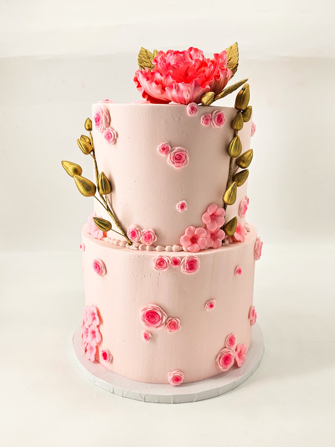 Pink floral two-tier cake made by Rose Cake Louisville